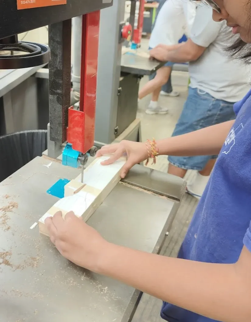 An action shot of me cutting my spatula on the bandsaw.